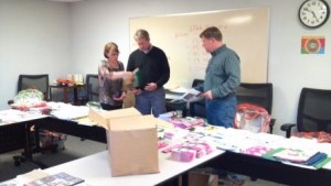 Funeral Director, Robert Hantge and Rich Westlund sort materials for Junior Achievement